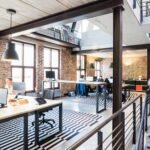 Spacious and stylish open-plan office with loft and industrial aesthetic.